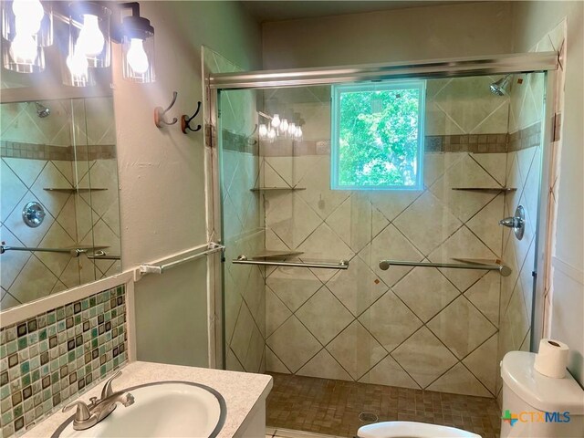 413 Vickers Ave, Seguin, TX 78155 - bathroom with toilet, vanity, and a stall shower