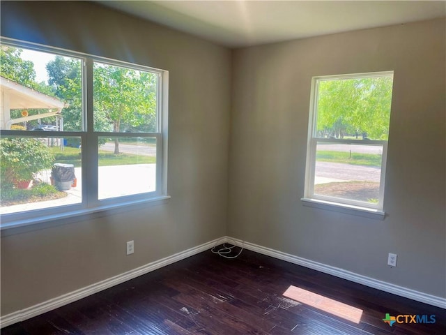 413 Vickers Ave, Seguin, TX 78155 - empty room featuring healthy amount of natural light, baseboards, and dark wood-type flooring