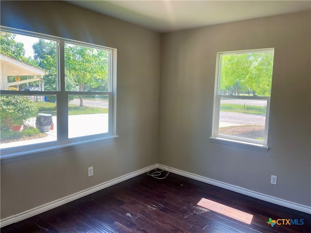 413 Vickers Ave, Seguin, TX 78155 - empty room featuring plenty of natural light, dark wood-type flooring, and baseboards