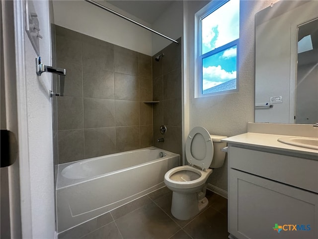 full bathroom with tile patterned floors, vanity, toilet, and tiled shower / bath