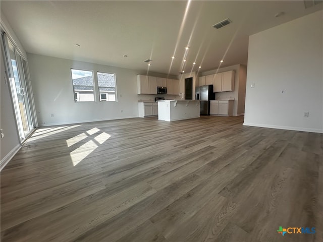 unfurnished living room featuring hardwood / wood-style flooring