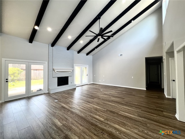 unfurnished living room featuring ceiling fan, high vaulted ceiling, dark wood-type flooring, french doors, and a brick fireplace