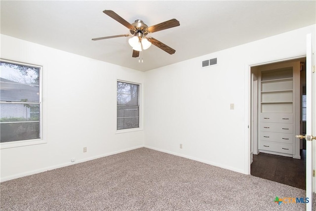 unfurnished room featuring carpet floors and ceiling fan