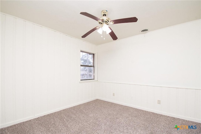 empty room with ceiling fan and carpet floors