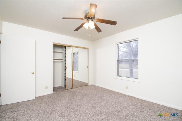 unfurnished bedroom featuring ceiling fan, a closet, and carpet floors