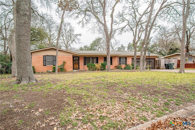 ranch-style home featuring a front lawn and a garage