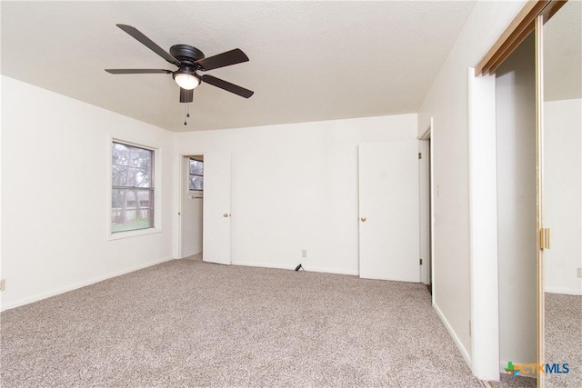 unfurnished bedroom with ceiling fan and carpet