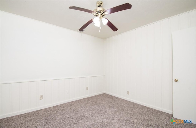 carpeted empty room featuring ceiling fan