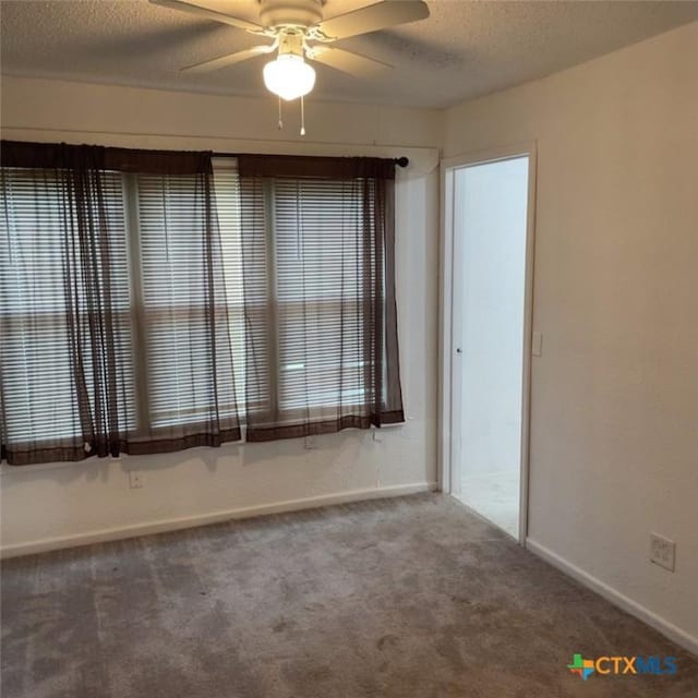 unfurnished room featuring carpet, a textured ceiling, and ceiling fan