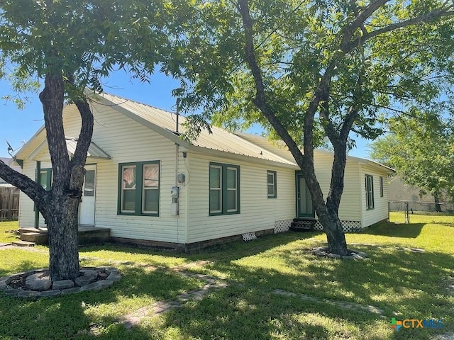 back of property featuring a yard