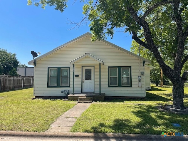 bungalow-style home featuring a front yard