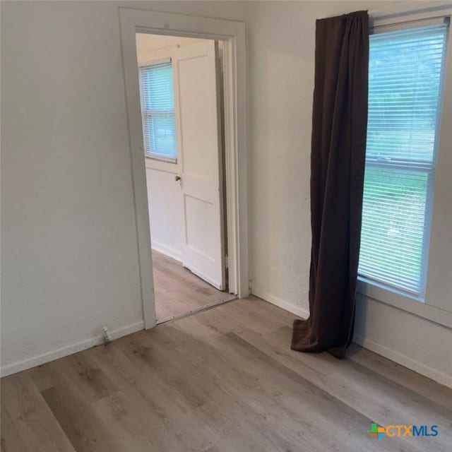 unfurnished room featuring light wood-type flooring