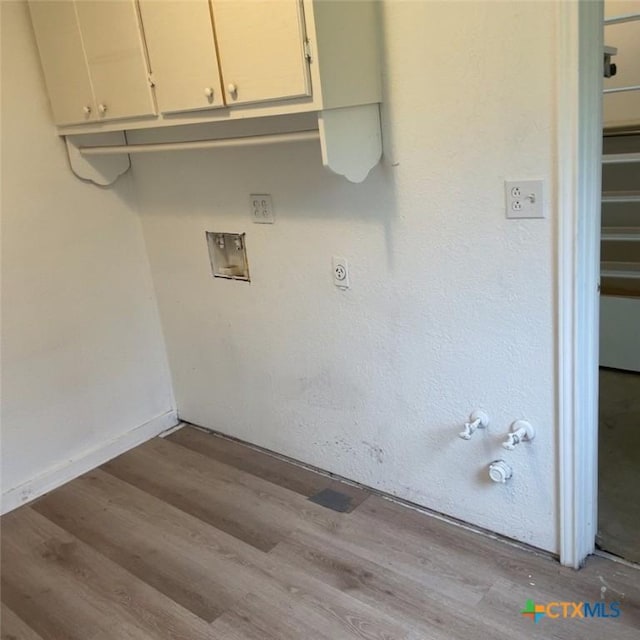 laundry room with cabinets, hookup for a washing machine, light wood-type flooring, and hookup for a gas dryer