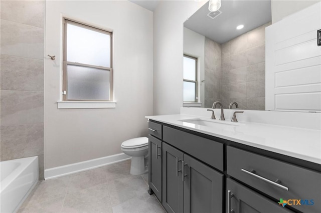 bathroom with a tub to relax in, visible vents, toilet, vanity, and baseboards