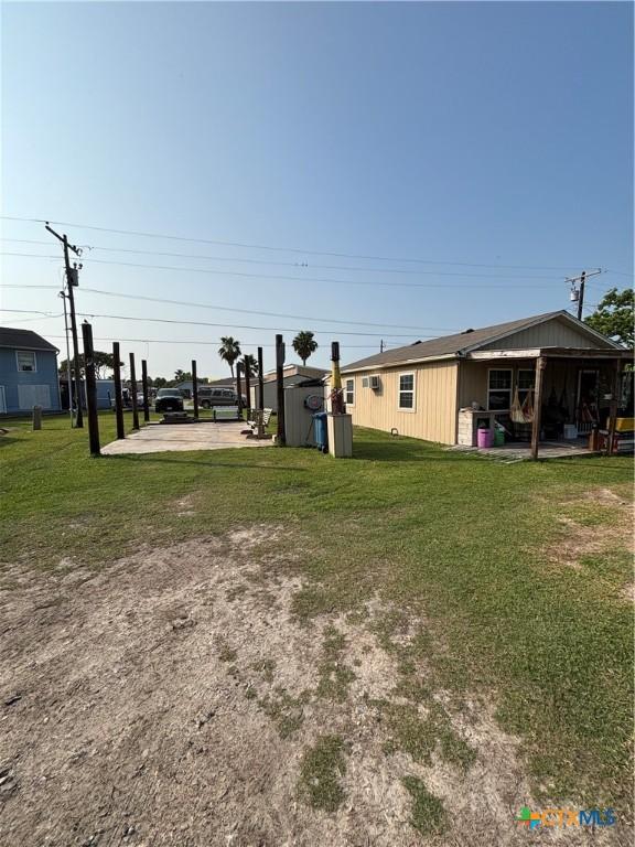 1208 W Adams St, Port Oconnor, TX 77982 - view of grassy yard with a patio