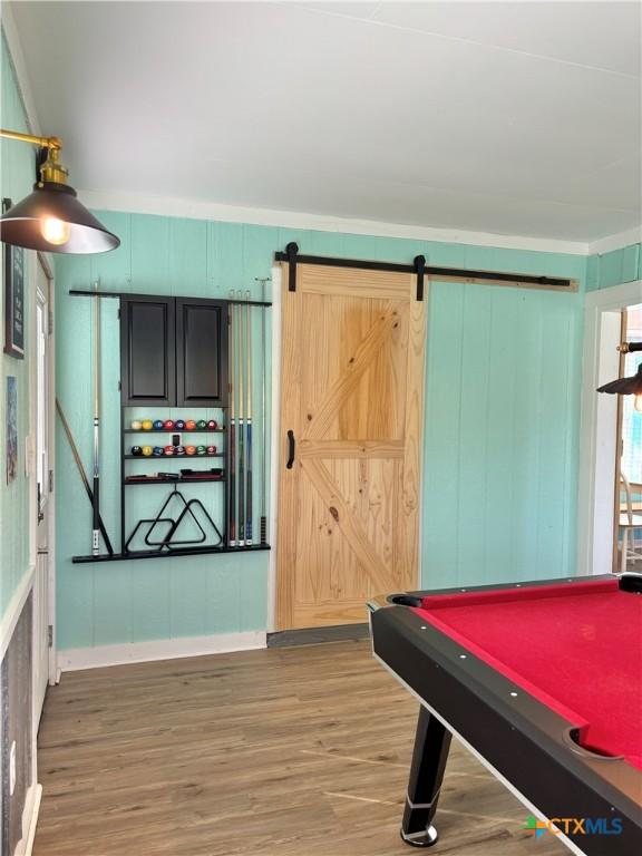 1208 W Adams St, Port Oconnor, TX 77982 - recreation room with wood finished floors, a barn door, and billiards table