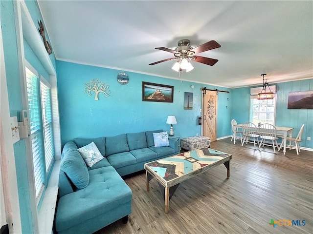 1208 W Adams St, Port Oconnor, TX 77982 - living area featuring a barn door, a ceiling fan, crown molding, and wood finished floors