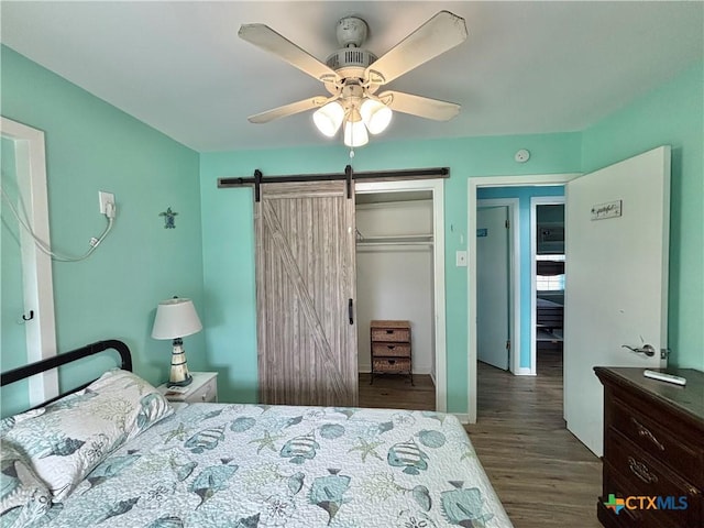 1208 W Adams St, Port Oconnor, TX 77982 - bedroom with a closet, wood finished floors, a barn door, and ceiling fan