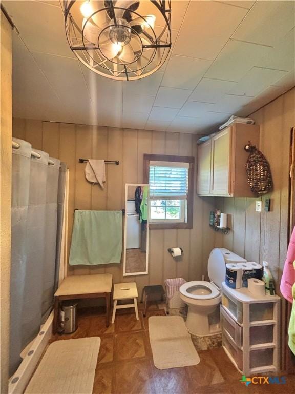 1208 W Adams St, Port Oconnor, TX 77982 - full bath featuring a stall shower, wooden walls, and a chandelier