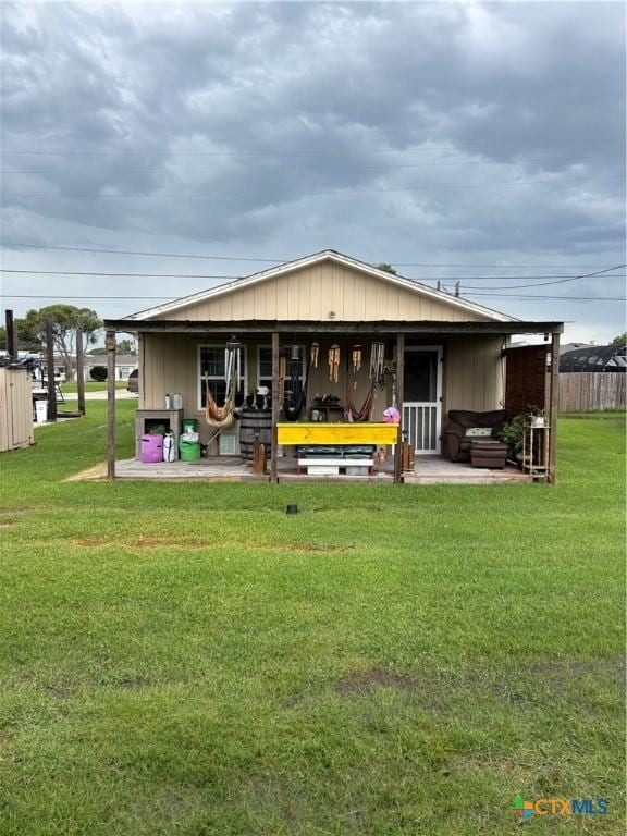 1208 W Adams St, Port Oconnor, TX 77982 - rear view of house with a lawn and a patio