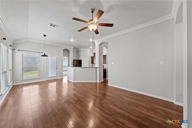 unfurnished living room featuring ceiling fan, dark wood-type flooring, vaulted ceiling, and ornamental molding