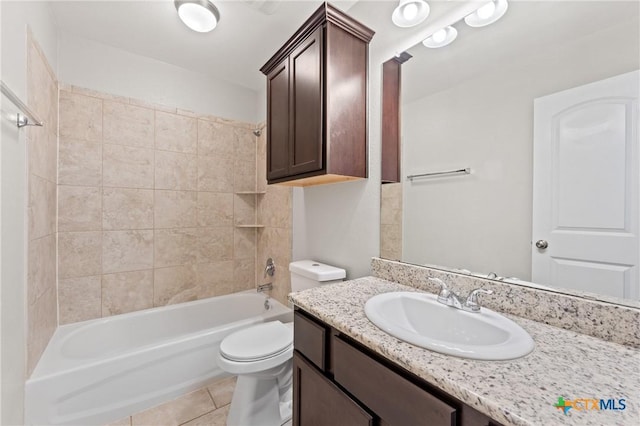 full bathroom with tile patterned flooring, tiled shower / bath combo, toilet, and vanity