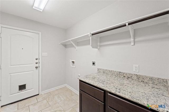 clothes washing area featuring hookup for an electric dryer, washer hookup, and cabinets