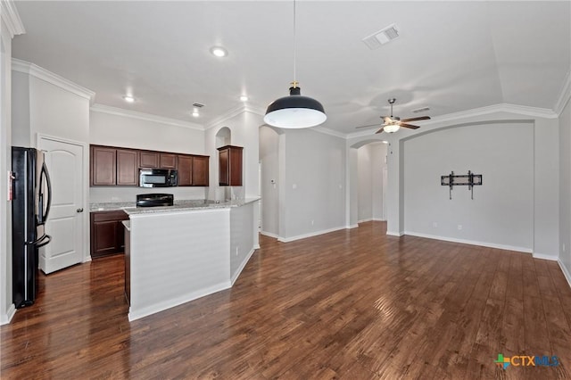 kitchen featuring dark hardwood / wood-style flooring, crown molding, and black appliances