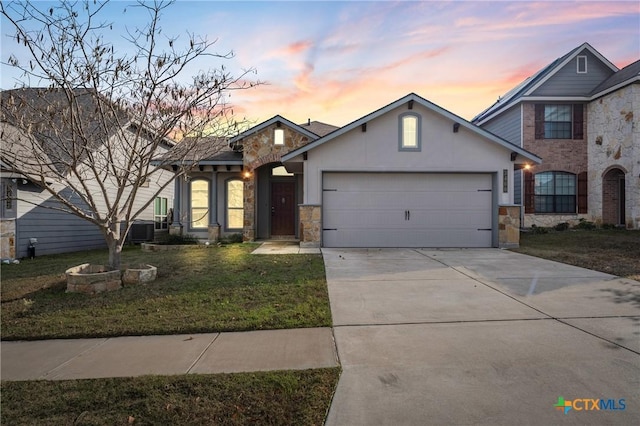 front facade featuring a lawn and a garage