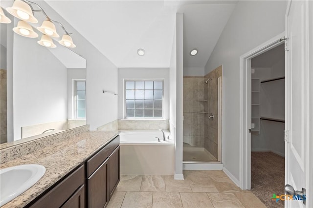 bathroom featuring vanity, shower with separate bathtub, and vaulted ceiling