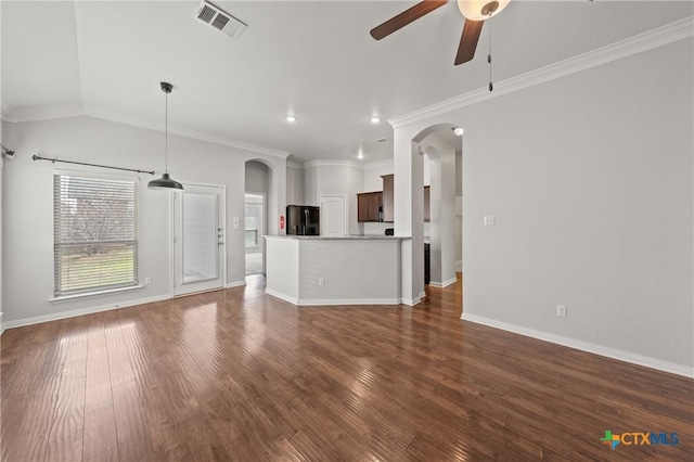 unfurnished living room with dark hardwood / wood-style floors, ceiling fan, and ornamental molding