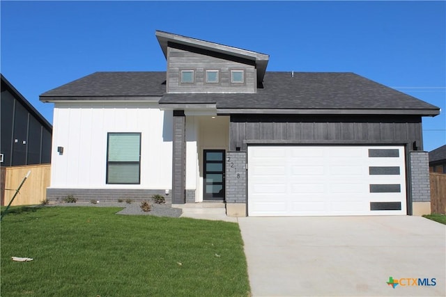 modern home with a garage and a front lawn