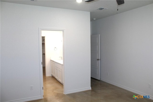 unfurnished bedroom with connected bathroom, a spacious closet, and ceiling fan