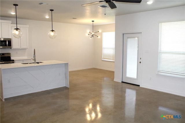 kitchen featuring plenty of natural light, sink, white cabinets, and stainless steel appliances