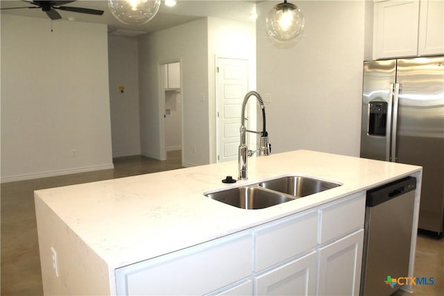 kitchen with sink, white cabinetry, stainless steel appliances, and an island with sink