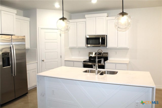 kitchen with an island with sink, white cabinets, hanging light fixtures, and stainless steel appliances