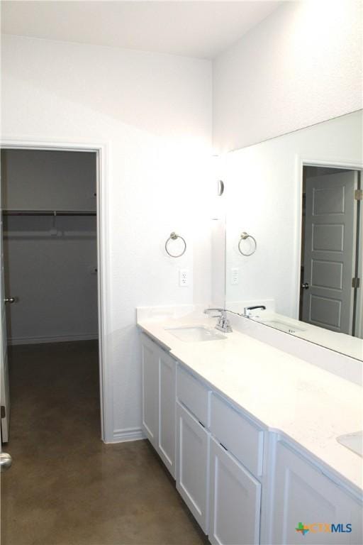 bathroom with vanity and concrete flooring