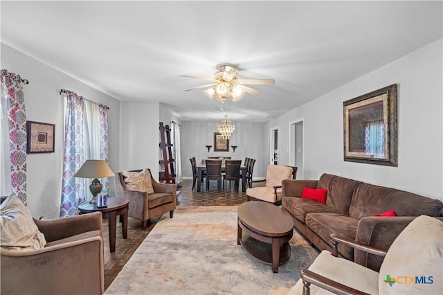 living room featuring ceiling fan and parquet flooring