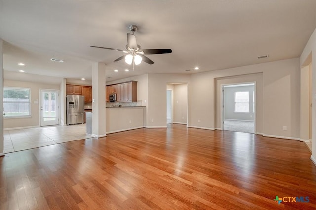 7400 Longford Trl, Austin, TX 78754 - unfurnished living room featuring a ceiling fan, recessed lighting, and light wood-style flooring