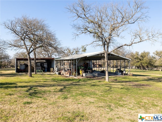 exterior space with an outdoor structure and a carport