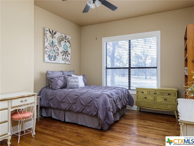 bedroom with wood-type flooring and ceiling fan