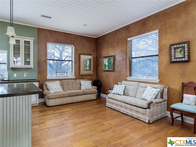 living room with wood ceiling, crown molding, light hardwood / wood-style flooring, and a wealth of natural light