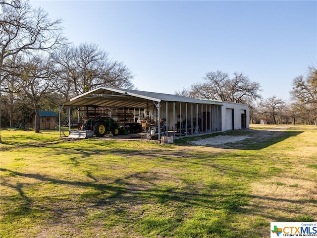 exterior space with a storage shed, a yard, and a garage