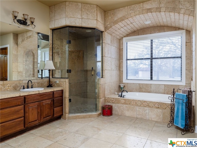 bathroom featuring tile patterned flooring, vanity, and separate shower and tub