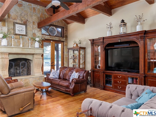 living room with french doors, light hardwood / wood-style flooring, wooden ceiling, a high end fireplace, and beam ceiling