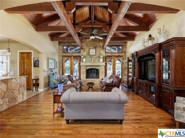 living room featuring wood ceiling, high vaulted ceiling, french doors, and light wood-type flooring