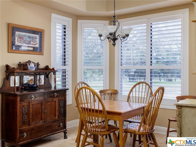 tiled dining area featuring a notable chandelier