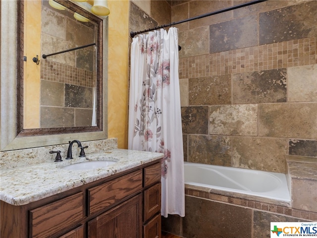 bathroom with shower / tub combo with curtain and vanity