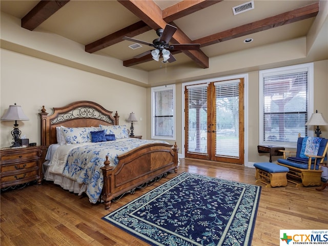 bedroom with hardwood / wood-style flooring, ceiling fan, access to exterior, beam ceiling, and french doors