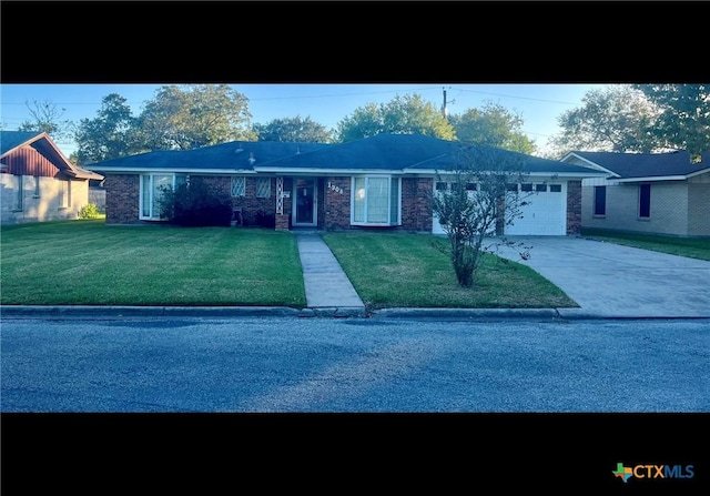 view of front of home with a front lawn and a garage